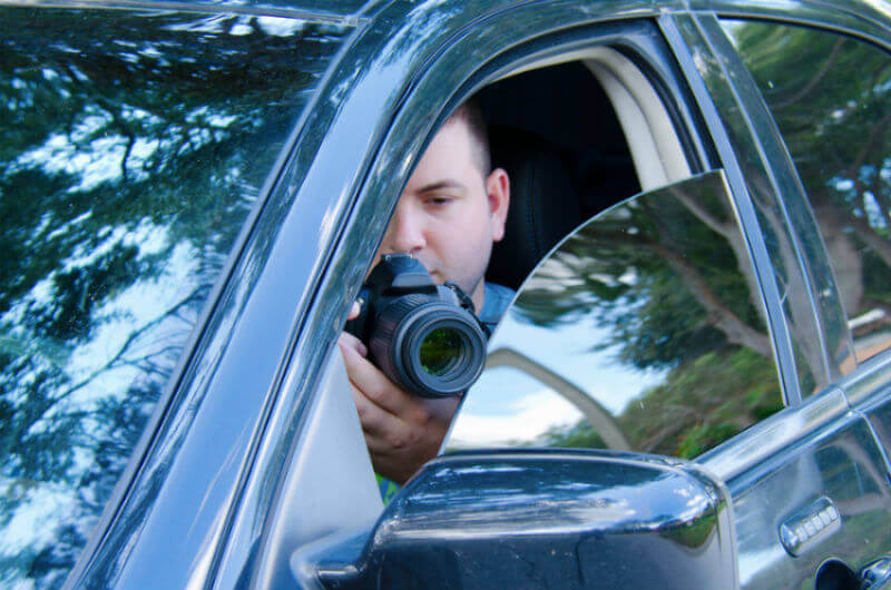 Private Investigator in car